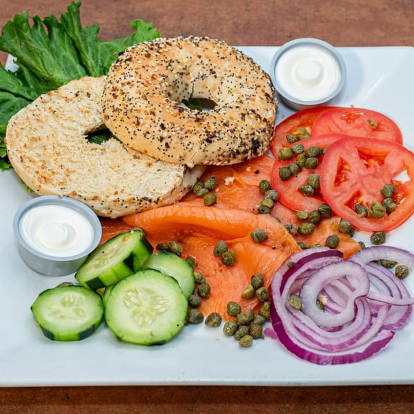 Ida's Cafe lox and bagel platter with capers, tomatoes, cucumbers, red onion, and cream cheese.